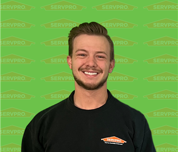 Male employee standing in front of Servpro background